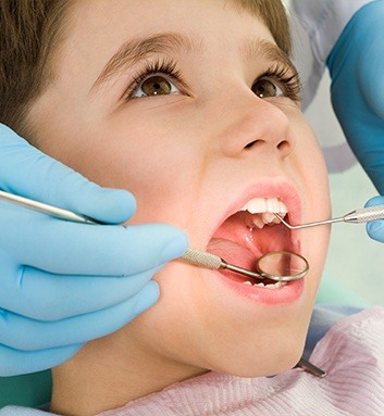 young boy getting dental checkup