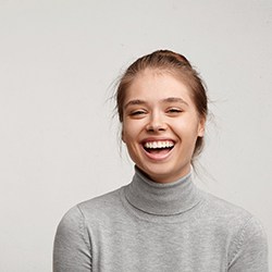 woman laughing with gray background