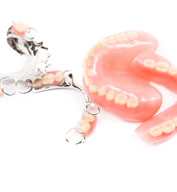 Different types of dentures on white background