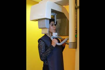 woman using dental x ray machine