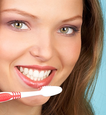 woman holding toothbrush