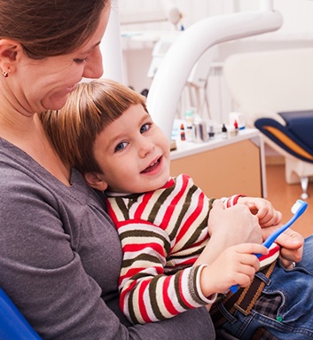 A little boy getting an exam from a dentist