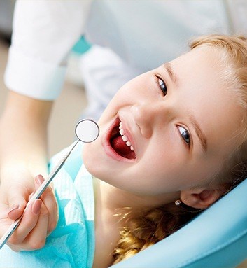 little girl in dental exam chair
