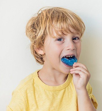 boy putting in mouthguard