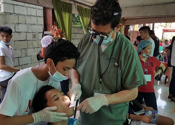 dentist working on adults smile