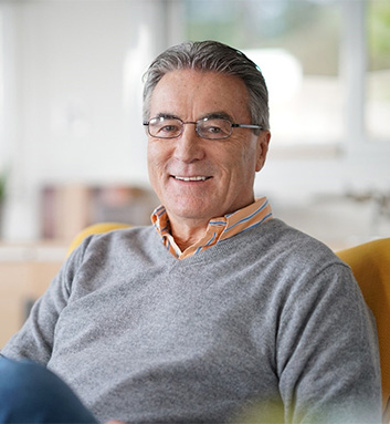 Man looking at cash in wallet