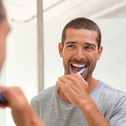 man brushing teeth