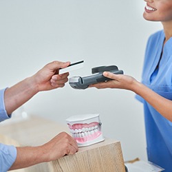 A patient paying the cost of their dental care