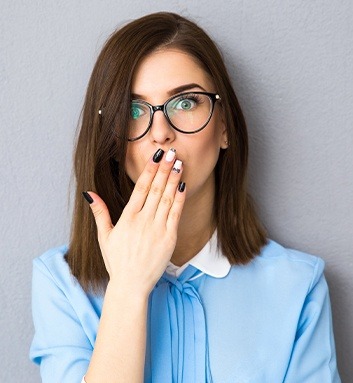 woman covering mouth