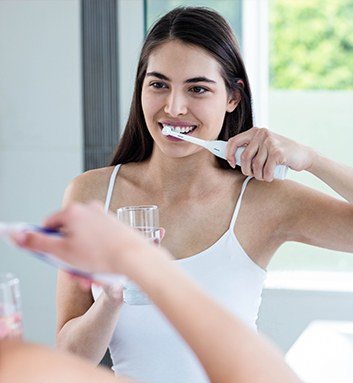 teen brushing her teeth