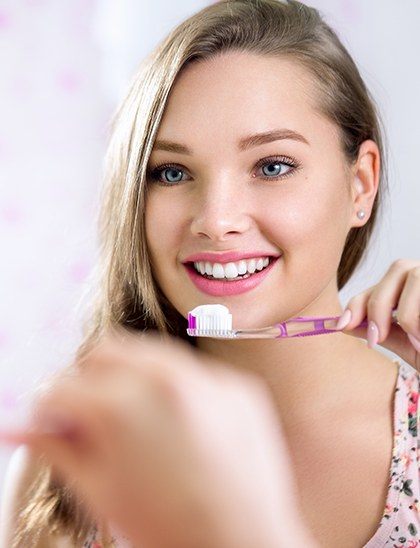 beautiful girl brushing teeth