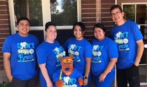 dental team in blue scrubs