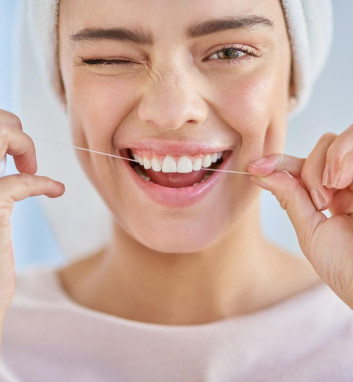 A woman flossing