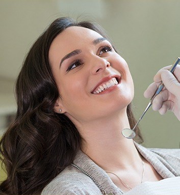 woman laying back in chair smiling at doctor