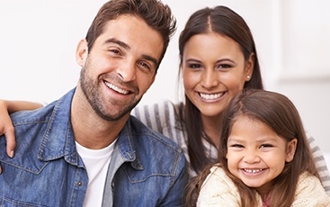 family of three smiling