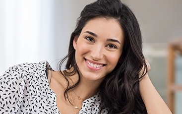 woman in black and white shirt smiling