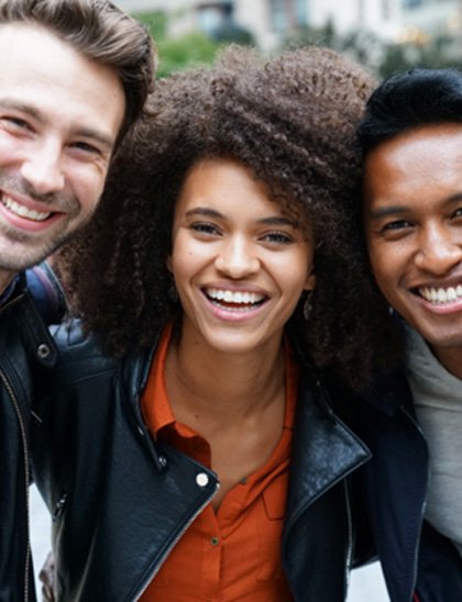 Group of friends smiling with dental veneers in Fort Smith