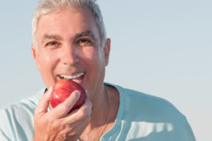 senior man eating an apple