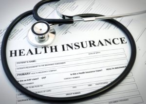 insurance forms with stethoscope